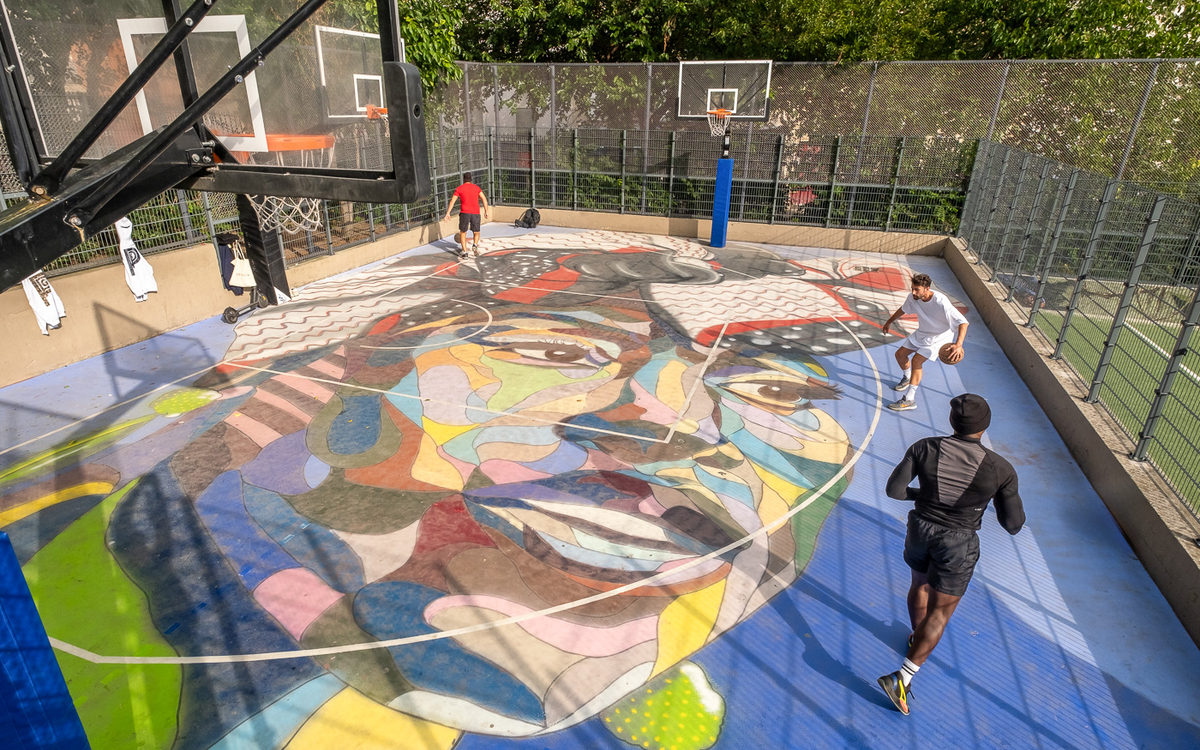Basketball players play on a court in Square Léon (18th district)