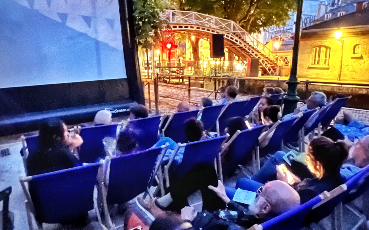 Photo d'une projection de cinéma en plein air sur les berges du canal Saint-Martin