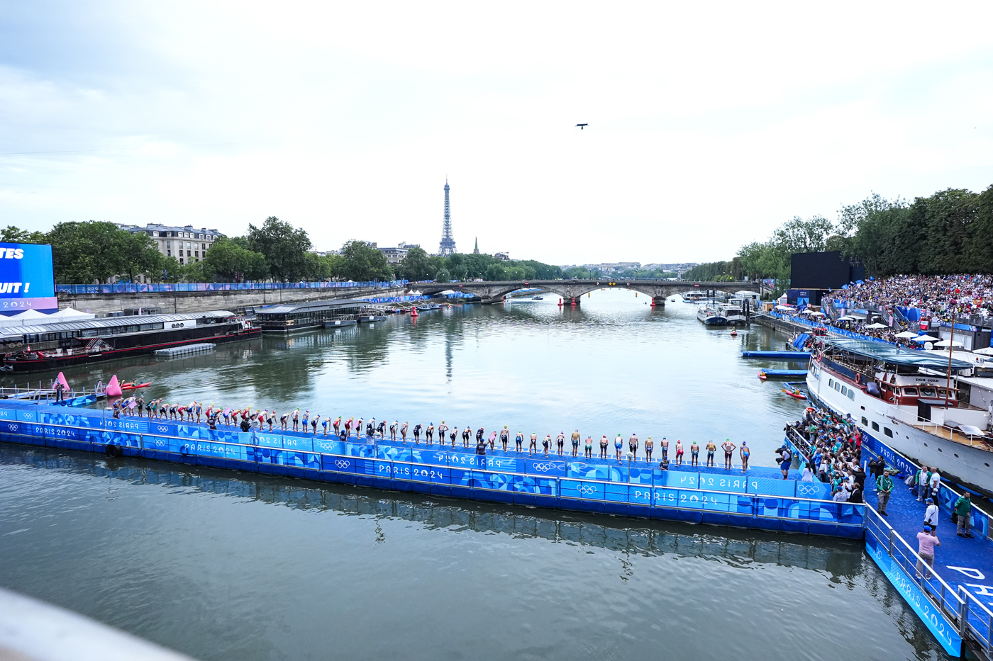 Ligne de départ du triathlon féminin depuis le pont Alexandre III avec la tour Eiffel en arrière plan.