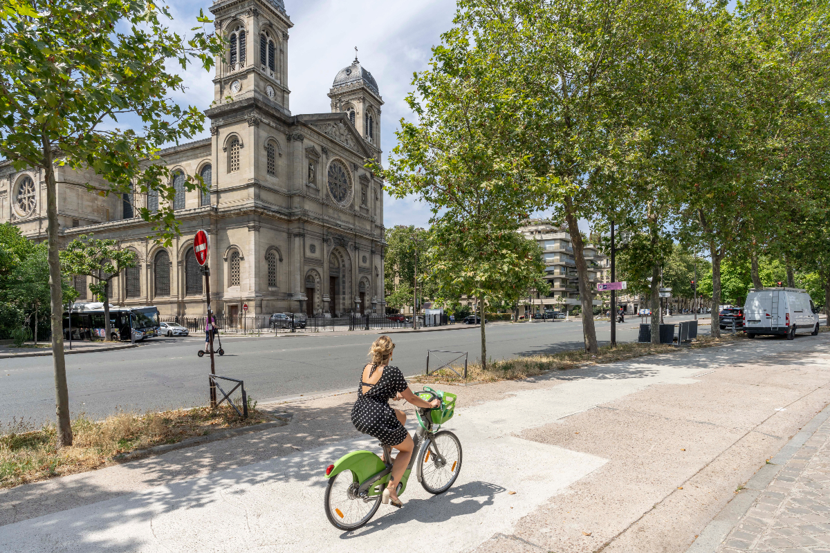 Une cycliste sur une olympiste boulevard des Invalides, face à l'église Saint-Francois_Xavier