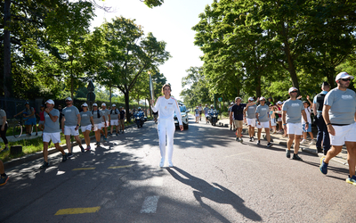 A female torchbearer runs in the Bois de Vincennes during the Paralympic Torch Relay.