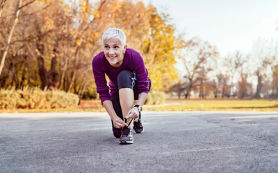 Une femme lace ses lacets avant de courir 