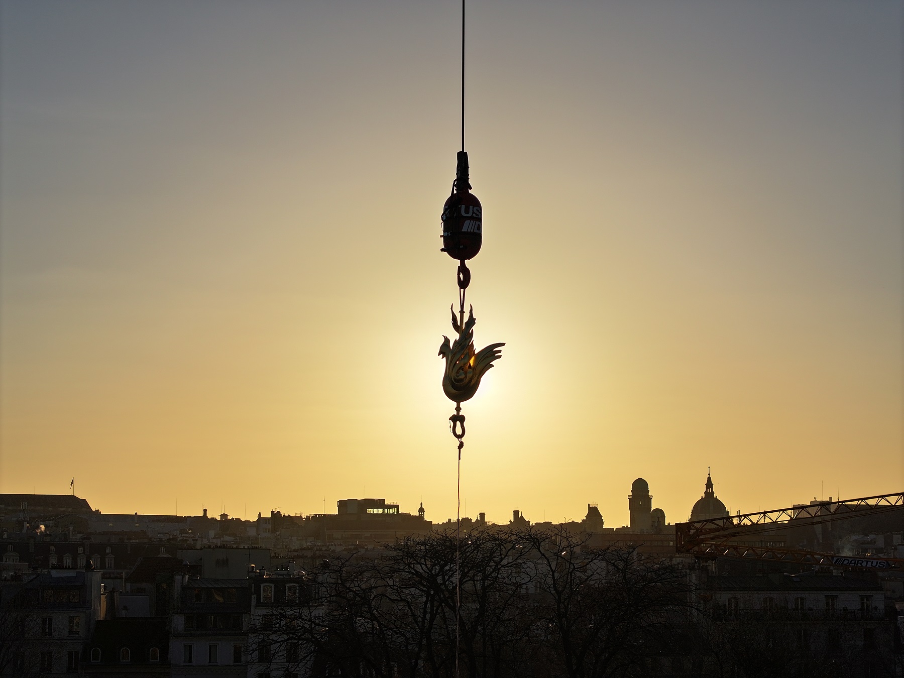 Déposé par une grue le coq vole dans le ciel de Paris