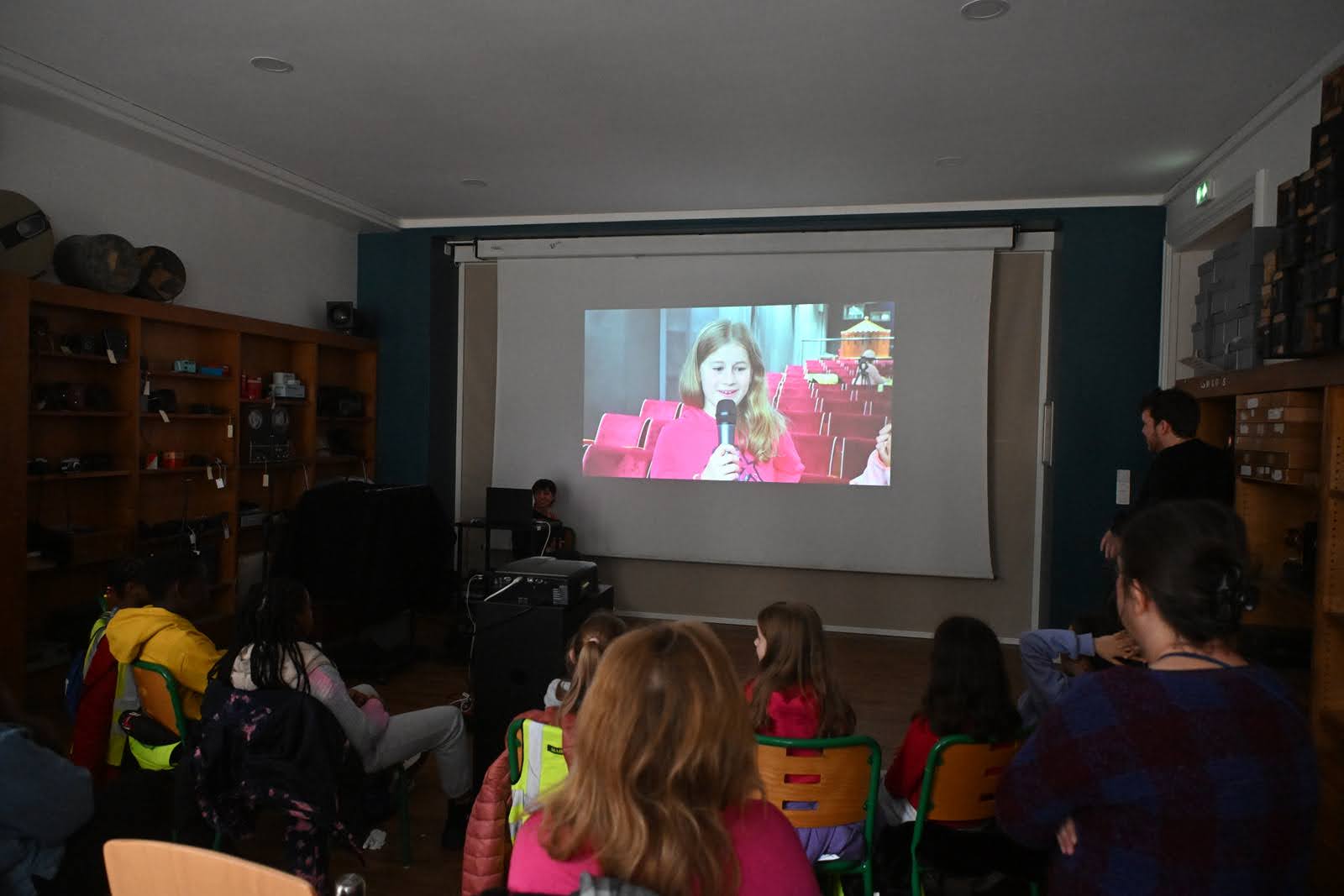les enfants regardent du grand écrans les vidéos d'eux faites par l'équipe de mon premier festival