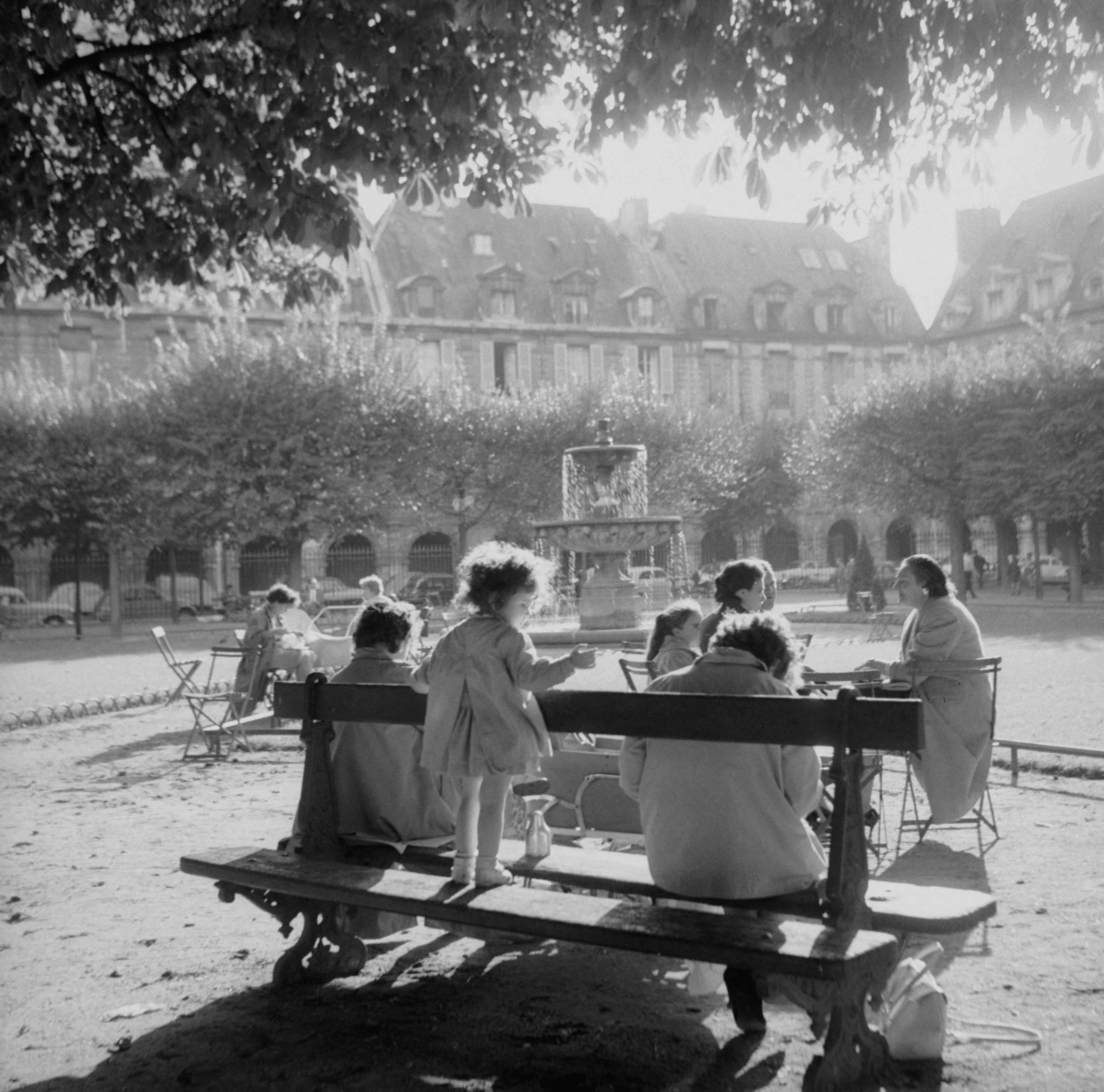 La place des Vosges, ses promeneurs, ses bancs. Paris 