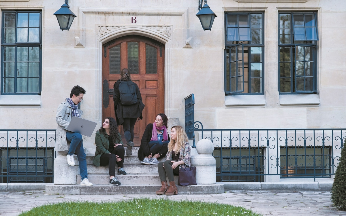 A group of young students sitting on steps
