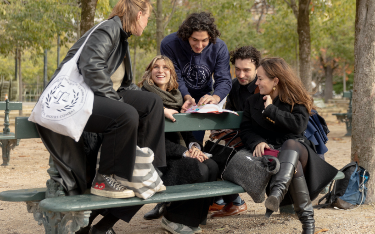 Des jeunes sont assis et examinent les possibilités offertes par la Ville de Paris