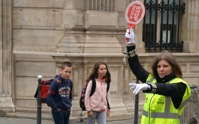Une surveillante fait traverser des enfants à proximité d'une école.