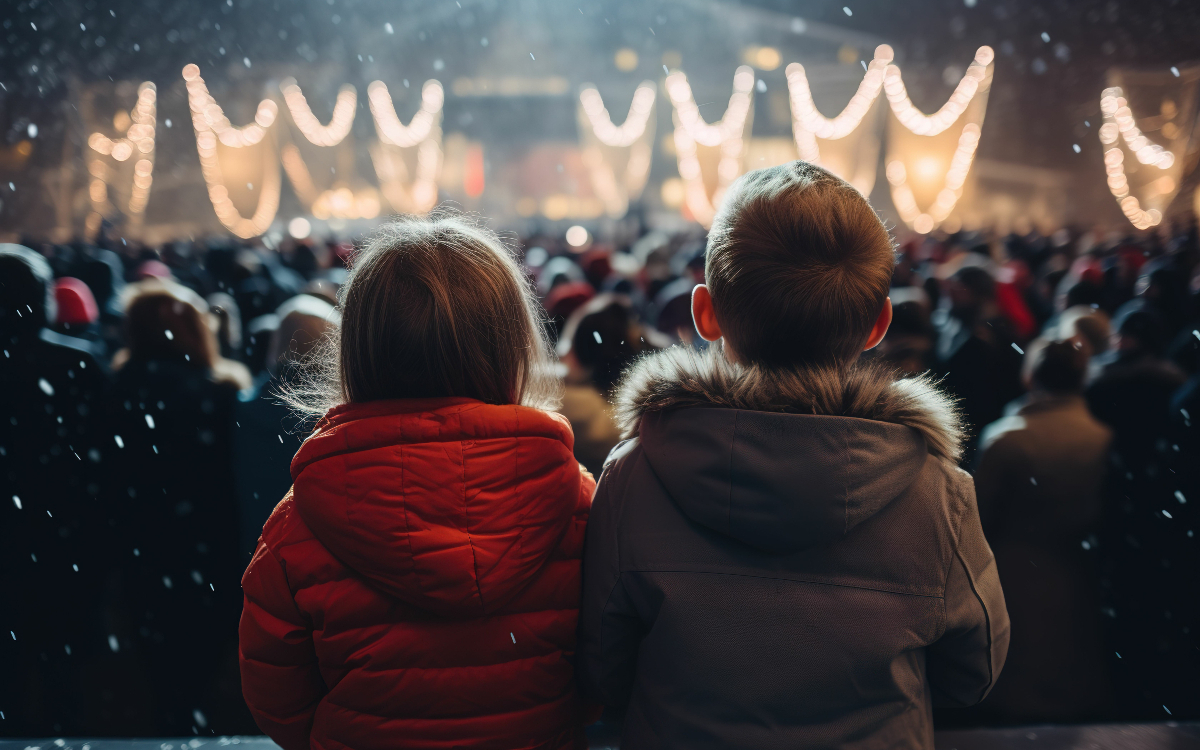 Deux enfants de dos qui regardent un spectacle 