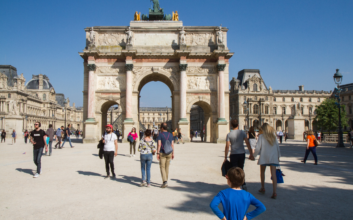Des touristes devant le caroussel du Louvre. 