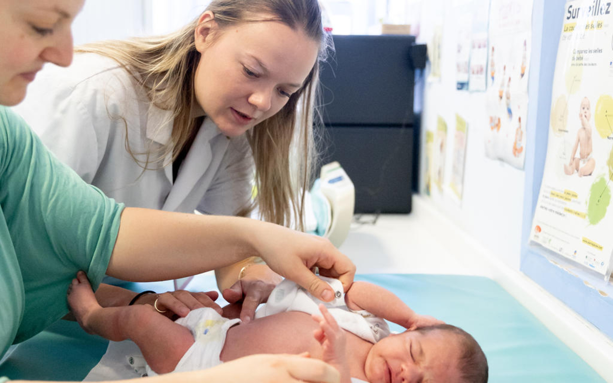 Un nouveau-né avec sa mère et une professionnelle de la petite enfance 