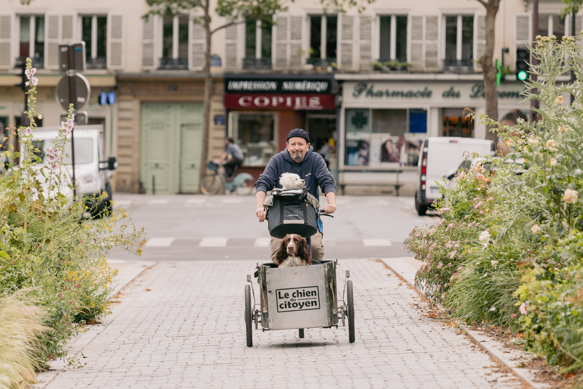 Alain Lambert sur son triporteur accompagné de ses deux chiens 