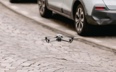 a drone taking off on a cobblestone street