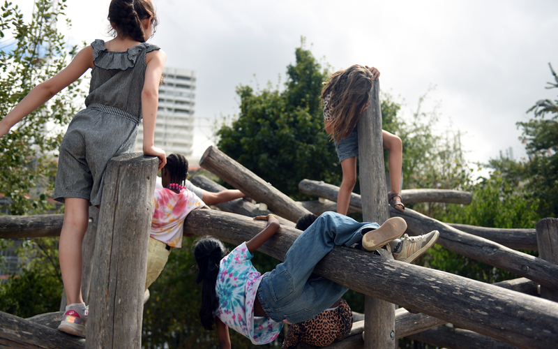 Des enfants s'amusent sur une structure en bois du parc Chapelle Charbon, 18ème.