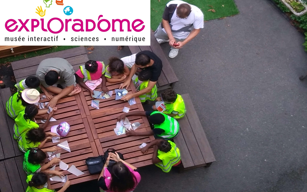 Un groupe d'enfants réalisant des expériences au jardin scientifique de l'Exploradôme.