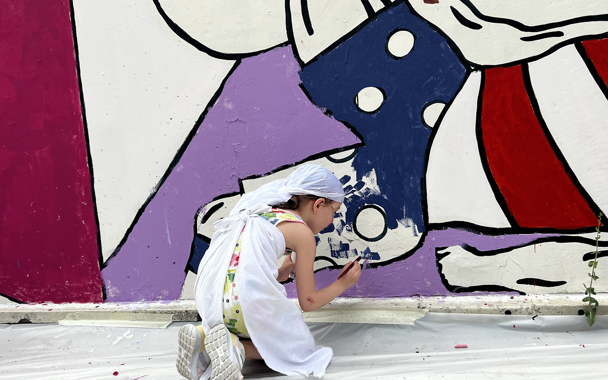 Child drawing on a wall
