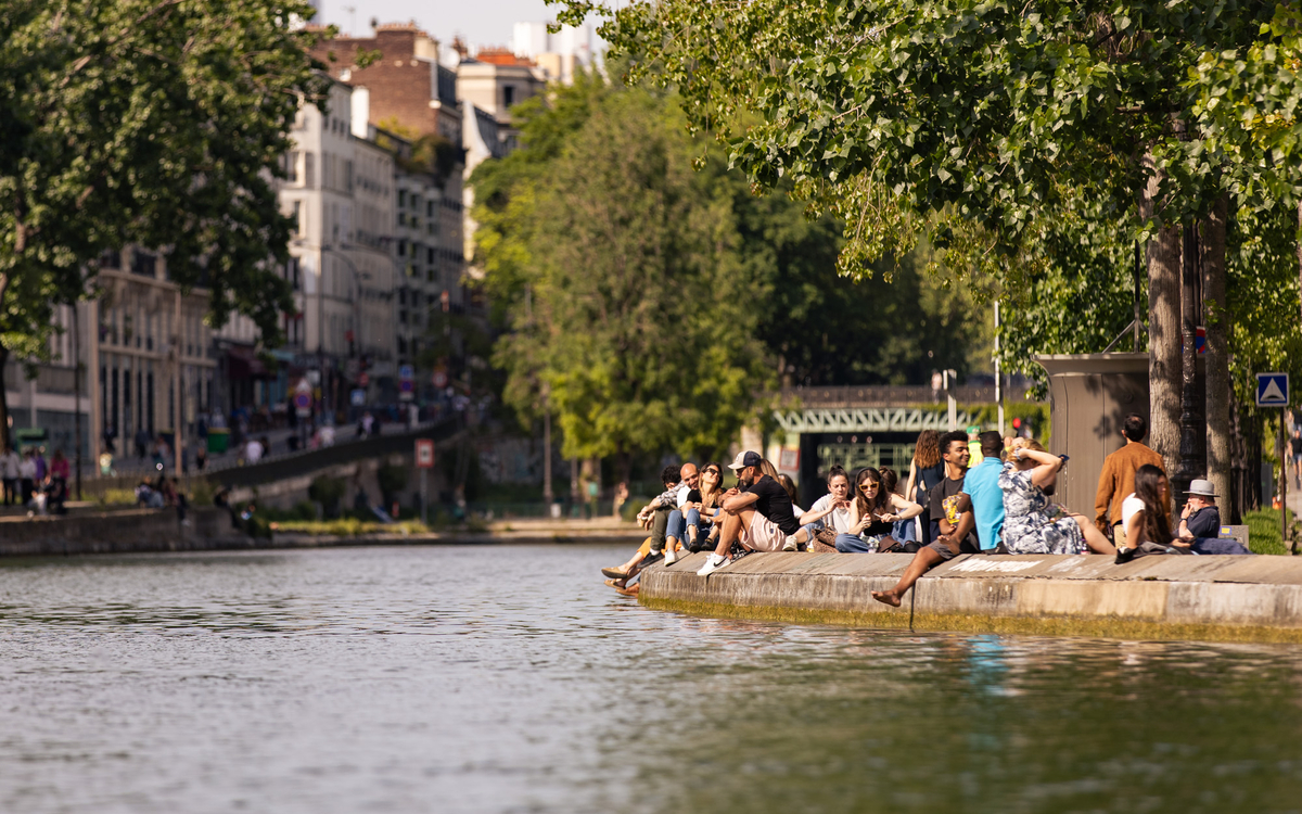 Parisians sitting in the sunshine on the banks of the Canal Saint Martin.