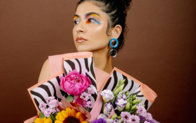 L'artiste Avantika  sur fond marron avec un bouquet de fleurs qui orne son buste