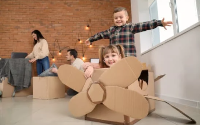 2 enfants construisent un avion en carton dans un atelier
