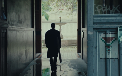 un homme marche un tableau sous le bras