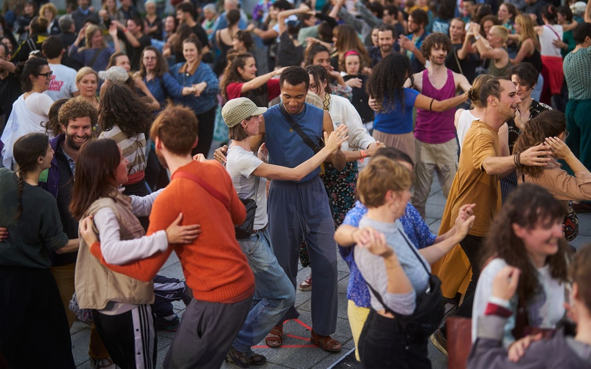 Une foule de personnes danse dans la rue